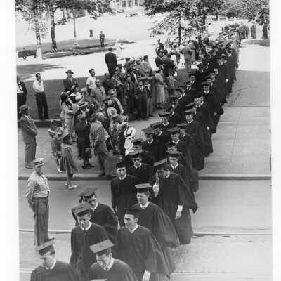 Students in cap and gown processing into cathedral for Baccalaureate service as part of 1950 graduation/commencement.