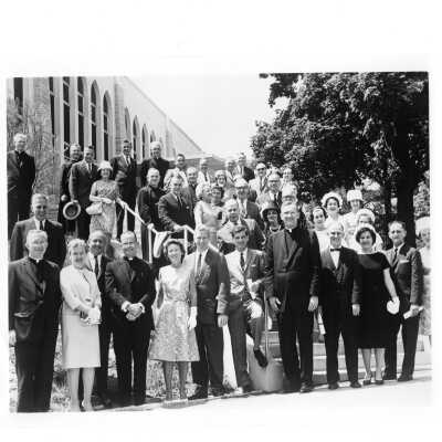 Alumni reunion of class of 1938, held June 1, 1963. Group photo of alumni and spouses taken outside of Drexel Library and includes William F. Maloney, S.J., Matthew Sullivan, S.J., Emory Ross, S.J.,and Michael Smith, S.J.,