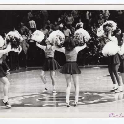 Women cheerleaders at basketball game, 1976.