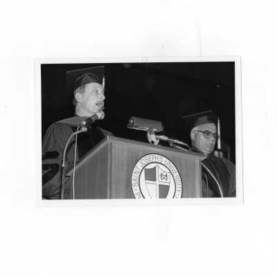 James R. Stormes, S.J., (?) reading citation to honorary degree recipient, Cesar Jerez-Garcia, S.J. during convocation, March 20, 1990 in Bluett Theater.