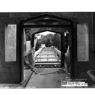View of pedestrian bridge under construction from McShain Hall entrance.