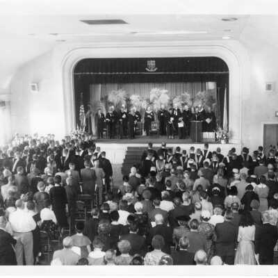 View of October 1954 graduation/commencement ceremony in Flanigan Auditorium.