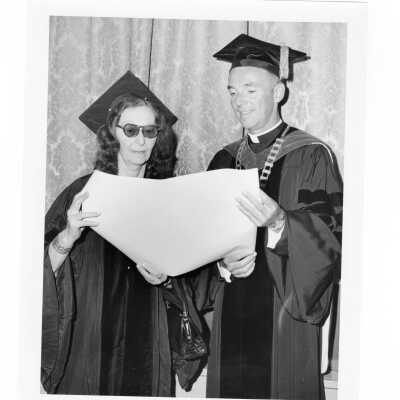 Terrence Toland, S.J., with honorary degree recipient, Violette de Mazia during September 1970 graduation/commencement,