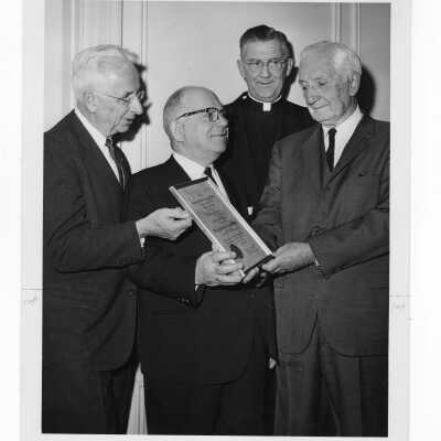 Dr. William N. Parkinson showing Shaffrey award certificate to Dr. Scarano, William F. Maloney, S.J., and Dr. George Ferrar, April 12, 1964.