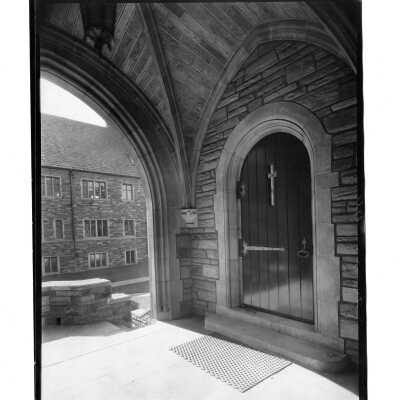 Exterior view of wooden door in central arch at main entrance of Barbelin building.
