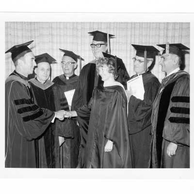 Terrence Toland, S.J., with six recipients of Bene Merenti medal during 1973 graduation/commencement. (C. Nash, C. Nash, M. J. Toconita, Francis J. Emory, S.J., Michael J. Blee, S.J., and Michael J. Smith, S.J.)