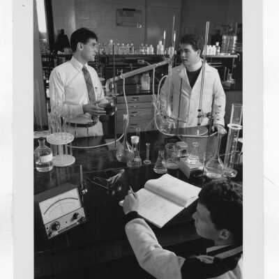E. Peter Zurbach (Chemistry) in laboratory with two students.