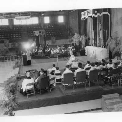 View of pontifical mass for centennial celebration held in Field House with Robert J. Gannon, S.J. giving sermon.