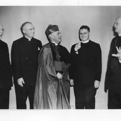 Edward G. Jacklin, S.J., Bishop George Leech, Archbishop Gerald O'Hara, Bishop Hugh Lamb, and Bishop Edward Fitzmaurice during banquet held in Field House as part of centennial anniversary celebration.