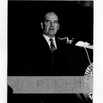Senator George McGovern delivering speech from podium in Field House, October 2, 1969.