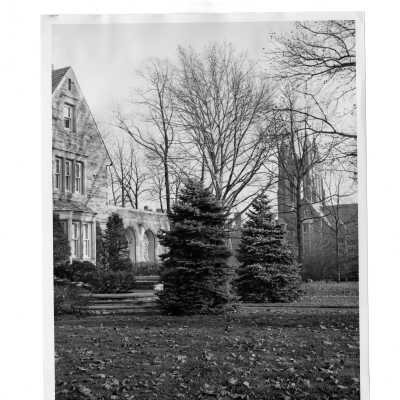 Exterior view of side of Regis Hall with Barbelin in background.
