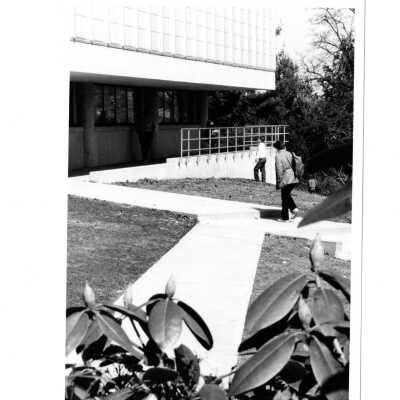 Exterior side view of addition (new wing) of Drexel Library with students walking alongside.