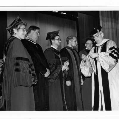 Nicholas S. Rashford, S.J., presenting the Bene Merenti medals to several faculty members, including Catherine S. Murray, Thomas J. Donahue, and others.