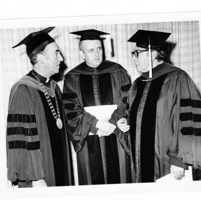 Terrence Toland, S.J., with two recipients of honorary degrees, Robert F. Drinan, S.J., and Philip J. Scharper during 1975 graduation/commencement.
