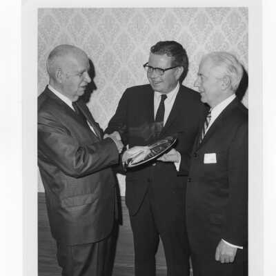 Charles A. Waters holding Law Alumni Award with others watching, November 28, 1967.