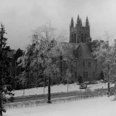 Exterior view of front of Barbelin building with snow and car in driveway.