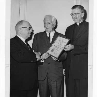 Dr. William N. Parkinson showing Shaffrey award certificate to Dr. Scarano and William F. Maloney, S.J., April 12, 1964.