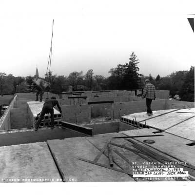 View of early McShain Hall construction with workmen.