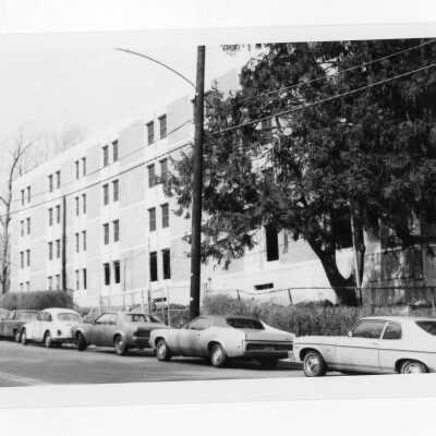 View of cars parked on Cardinal Avenue with Sourin Residence Center in background.