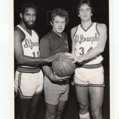 Men's Basketball Coach Jimmy Lynam with two players