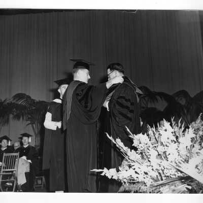 Edward G. Jacklin, S.J., bestowing honorary degree on Reverend John J. Maher of Scranton at 1953 graduation/commencement ceremony.