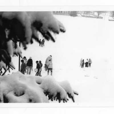 Students walking on Finnesey Field during snow.