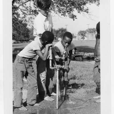 Mike DiBerardinis (?) working with children in recreation program as part of summer community service/outerach program in "The House" or SJC Commune at 17th and Girard Streets, Philadelphia.