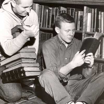 Interior view of two students unpacking books in Drexel Library after being moved from Barbelin.
