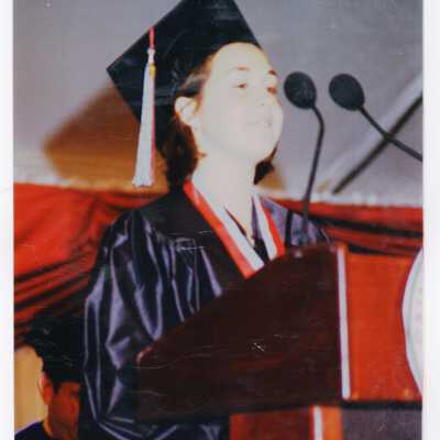 Graduating student, possible Nicole Franck (?) addressing audience during 1999 graduation/commencement.