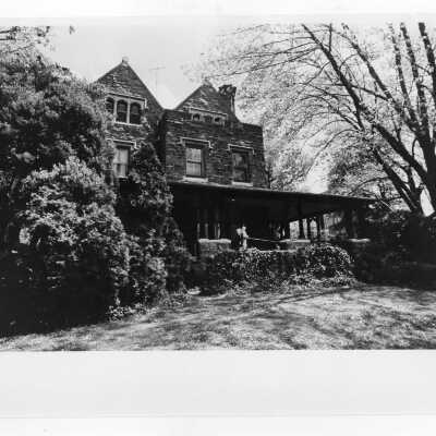 View of side porch of Wolfington Center (formerly Gest Estate, Neumann Hall) in spring.