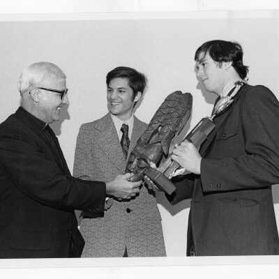 Two students from Villiger Debating Society, Dennis Marc Klinman and Gerald A. McHugh, presenting trophy to Father Burke. with trophy.