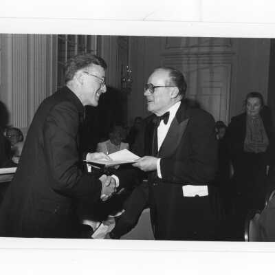 Donald I. MacLean, S.J., handing awards to Leo T. Connor, Vincent J. Cattie, M.D., Robert W. Donahue, and Andrew Dougherty at alumni awards dinner, c. 1980.