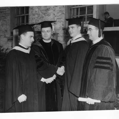Edward G. Jacklin, S.J., with Francis C. Nash and two graduates, Francis Dieter and John Molloy, at 1952 graduation/commencement.