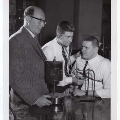 Biology professor Carroll B. Nash with two students in science laboratory, February 1963.