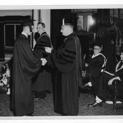 Tropaia exercises during 1955 graduation/commencement with Edward G. Jacklin, S.J., student, Matthew Sullivan, S.J., and others.