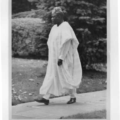 Member of entourage from government of Chad walking on sidewalk during convocation, October 26, 1970.