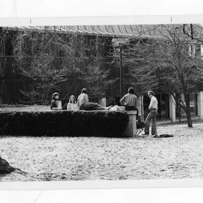 Students sitting on wall and talking outside Campion.