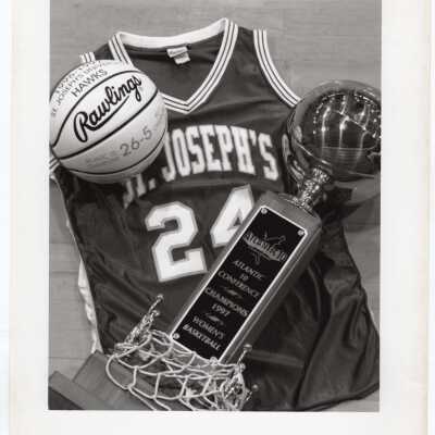 Women's Basketball - collage of a jersey, ball, net, and trophy for Atlantic 10 Conference Champions 1997