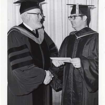 Dr. James E. Dougherty giving J. Richard Houston the Lnidback Foundation Award?