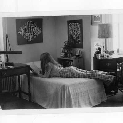 Woman student studying in dormitory room.