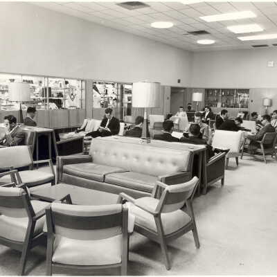 Interior view of Campion student lounge with students and bookstore in background.