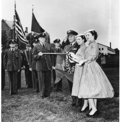 Air Force ROTC ceremony with Eileen Nolan and Kathleen Nolan (twins wearing striped dresses) and Col. James O'Connell and others.