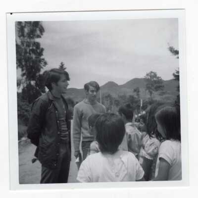Two students talking with group of children in Colombia during Latin American Studies Institute Summer Service Project, summer 1970.