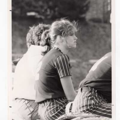 Women's softball players sitting on bench during game against Lehigh University.
