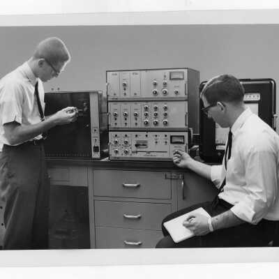 Two students working with equipment in science laboratory.