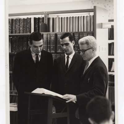 Business Administration Chair, Lawrence J. Bell, working with students in the Drexel Library, c. 1965.