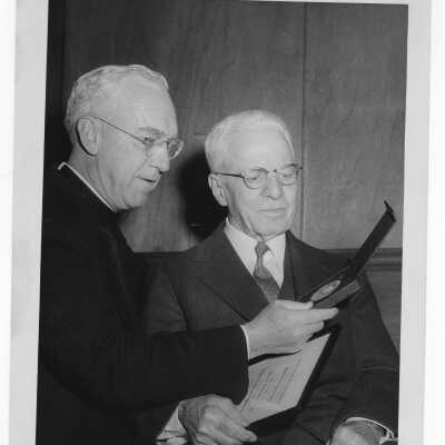 Dr. J. Parsons Schaeffer showing Shaffrey award medal to J. Joseph Bluett, S.J., 1959.