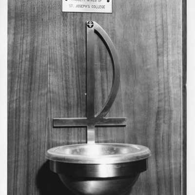 Font in chapel in Barbelin with plaque stating that it was donated by the faculty wives of Saint Joseph's College.