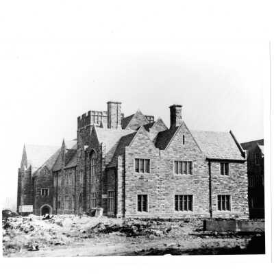 Exterior view of Barbelin building near end of construction with sign, "Joseph M. More and Sons, Mason Builders." [?]