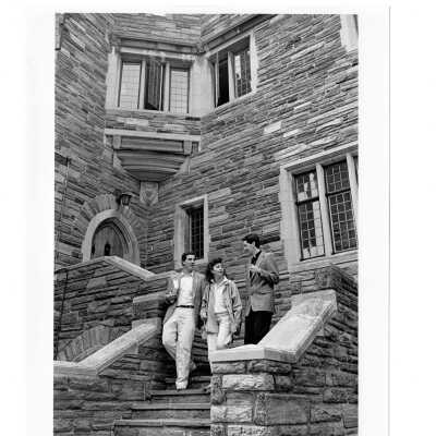 Exterior view of steps in Barbelin quadrangle with Father Rob McChesney and two students descending steps.